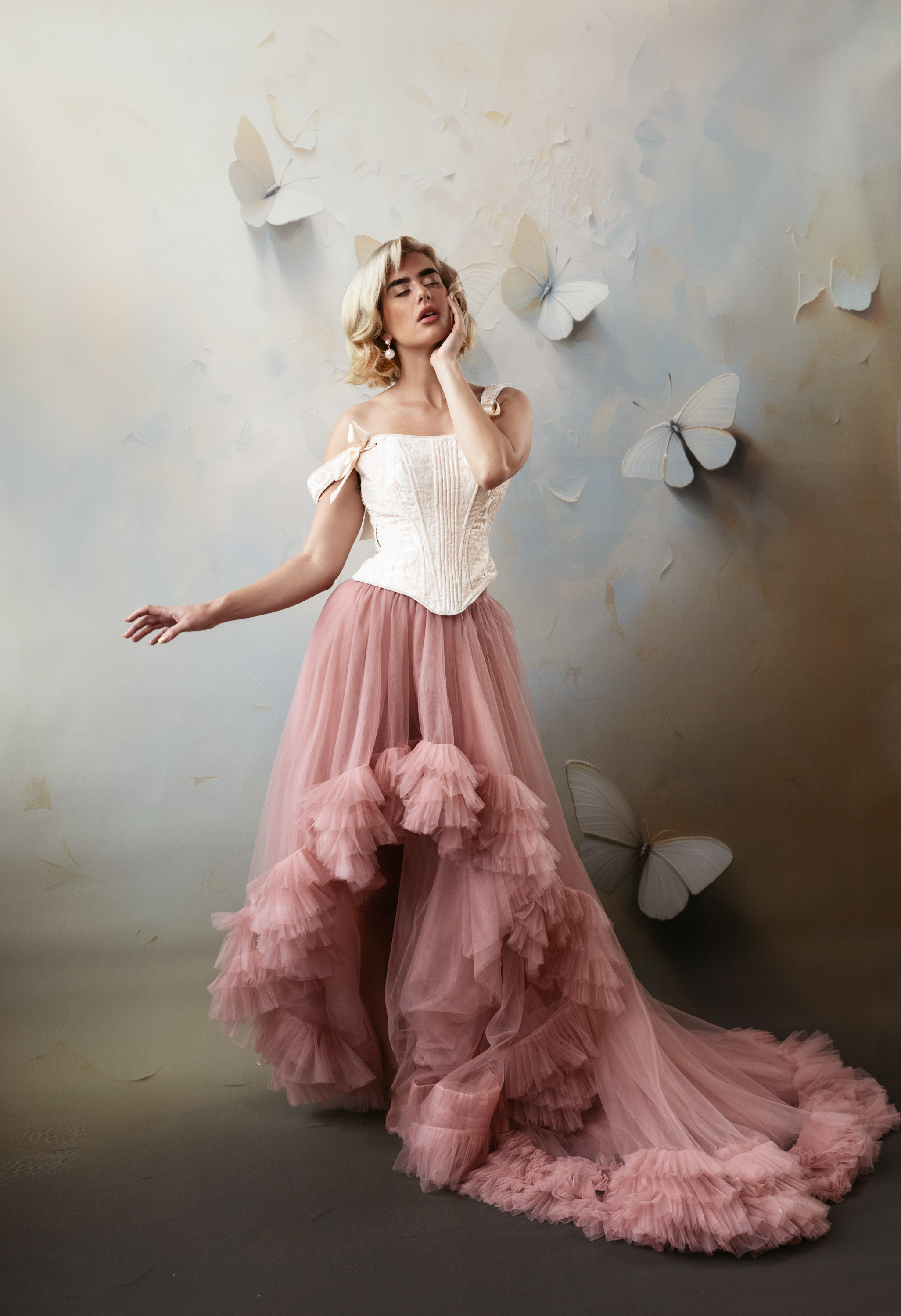 Dawn Muensterman in a blush ruffled tulle gown on a painted butterfly set